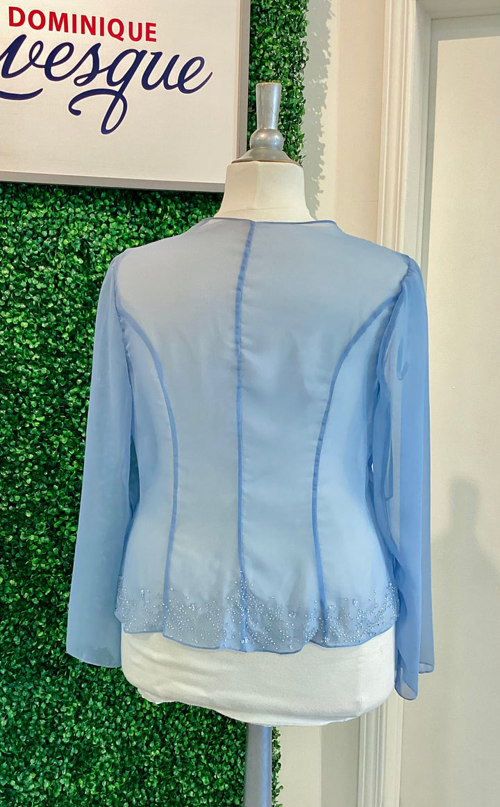Light blue jacket on a mannequin against a green leafy background with &
