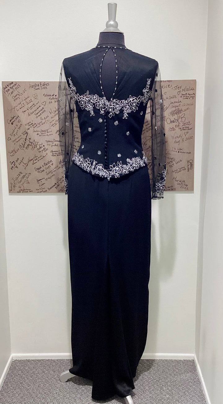 Navy evening gown with silver embellishments on a mannequin against a plain background