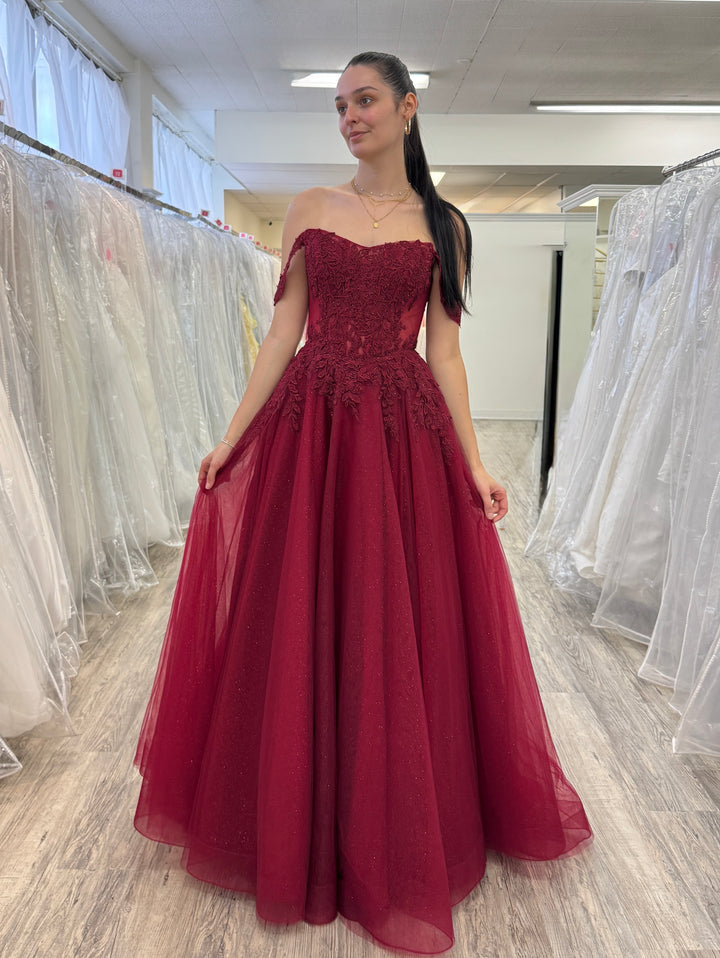 Woman wearing a burgundy prom dress