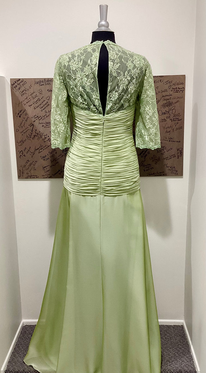 Green lace dress on a mannequin against a plain background.