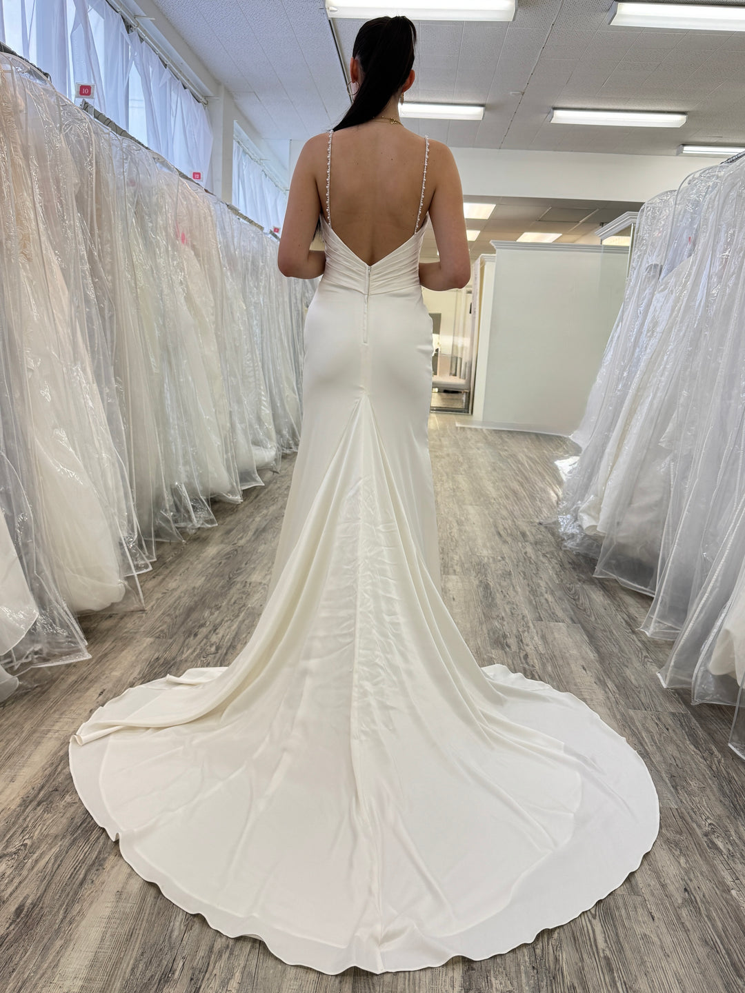 Woman wearing a white wedding dress in a store