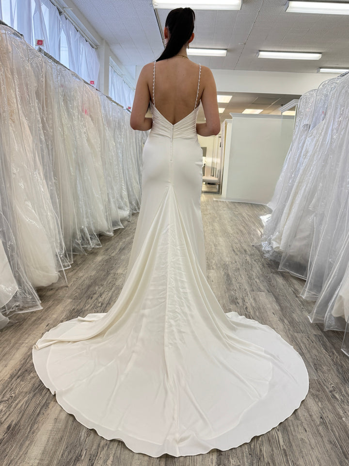 Woman wearing a white wedding dress in a store