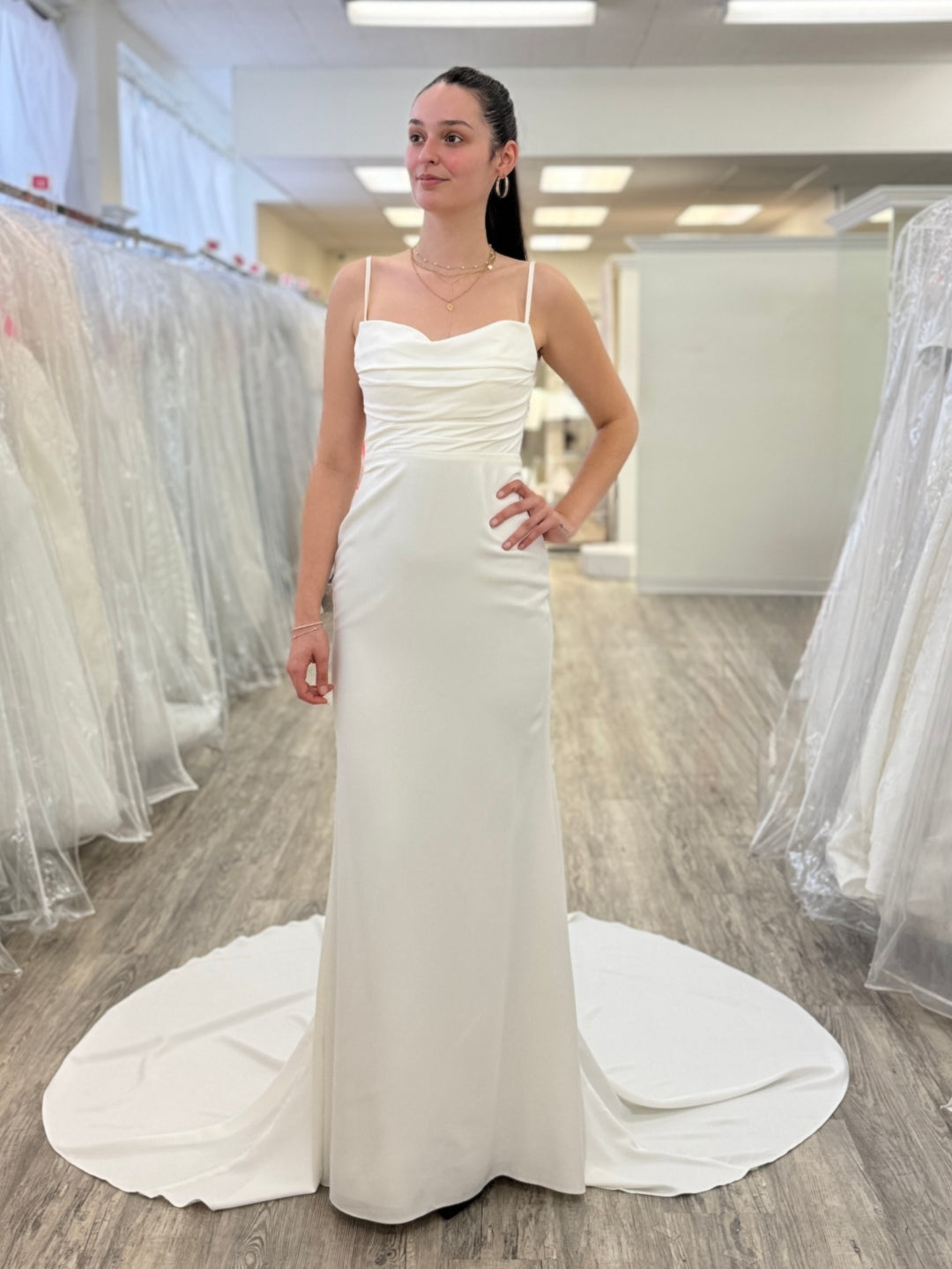 Woman wearing a white wedding dress in a store setting