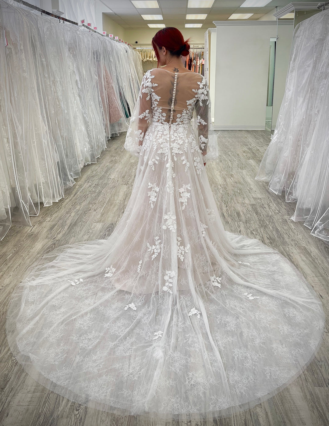 Blush wedding dress with long sleeves.