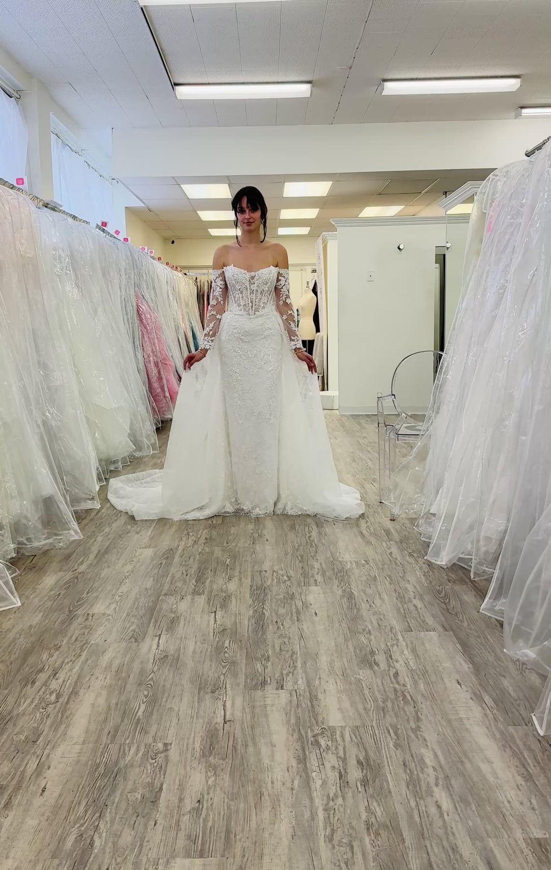 Woman walking in a lace wedding dress holding the overskirt