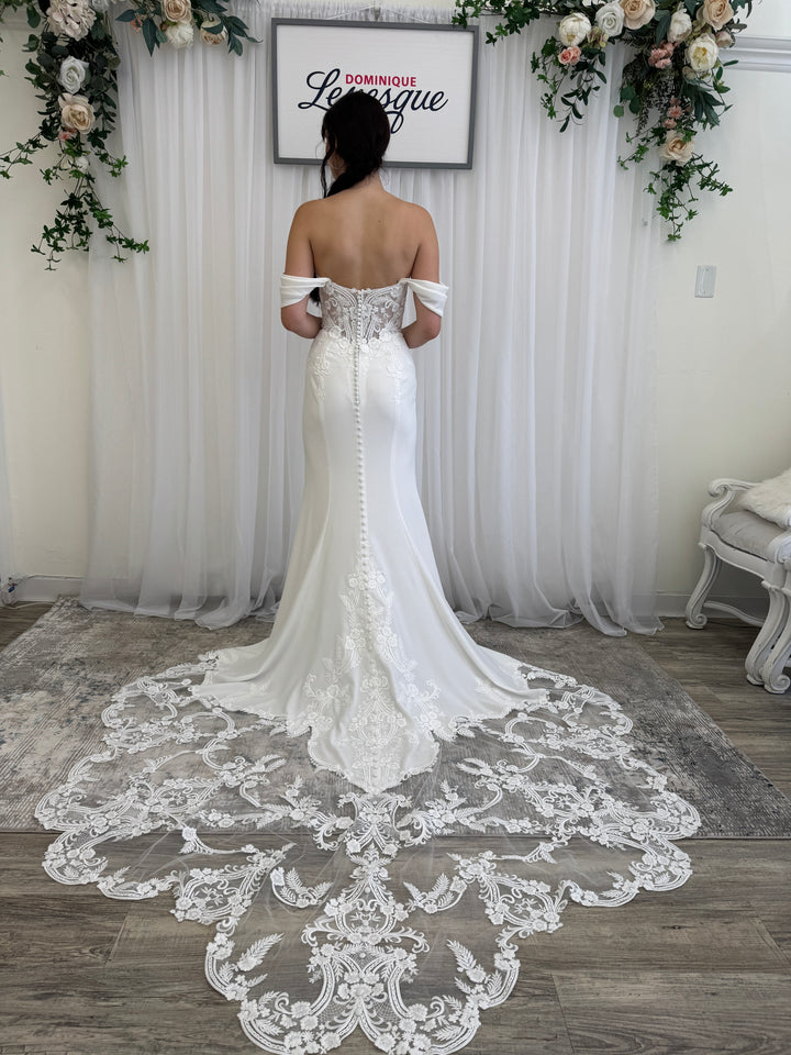 Women in a wedding dress showing the lace train