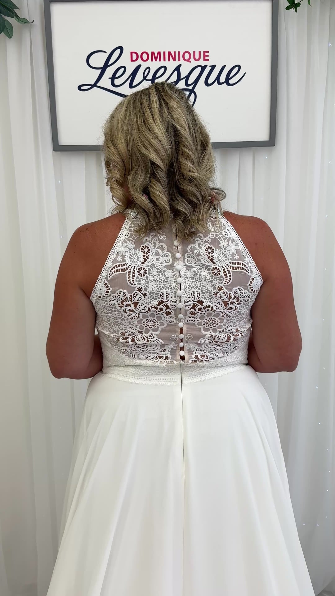 Back of chiffon and lace wedding dress on a women