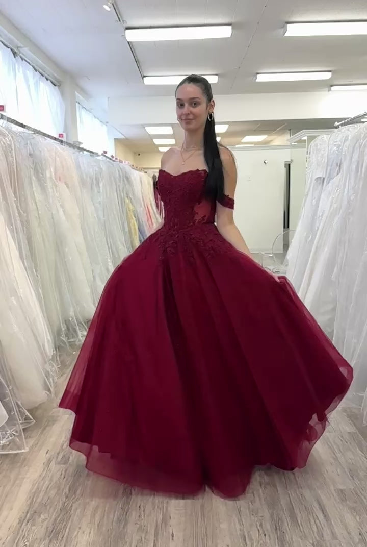 Girl spinning in a burgundy prom dress