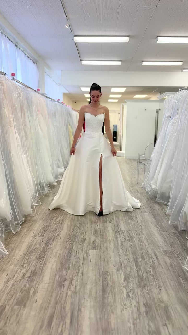 women walking in a wedding dress in a store 